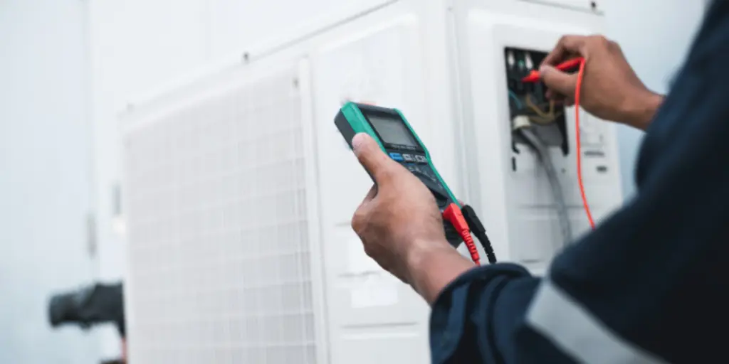 Technician checking an AC unit